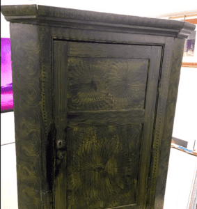Antique carved wooden cabinet with sunburst panels