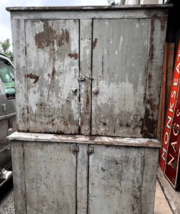 Weathered metal storage cabinet with peeling paint