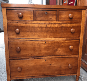 Antique wooden chest of drawers with knobs