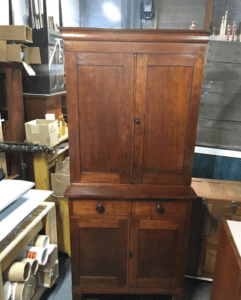 Antique wooden cabinet with drawers and doors