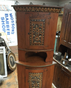Antique carved wooden corner cabinet with painted panels