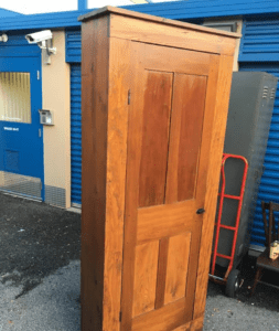 Tall wooden wardrobe standing outdoors