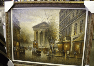 Framed painting of rainy European city street