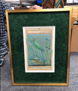 Gold-framed Persian miniature of green parrot