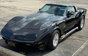 Black classic Chevrolet Corvette in parking lot